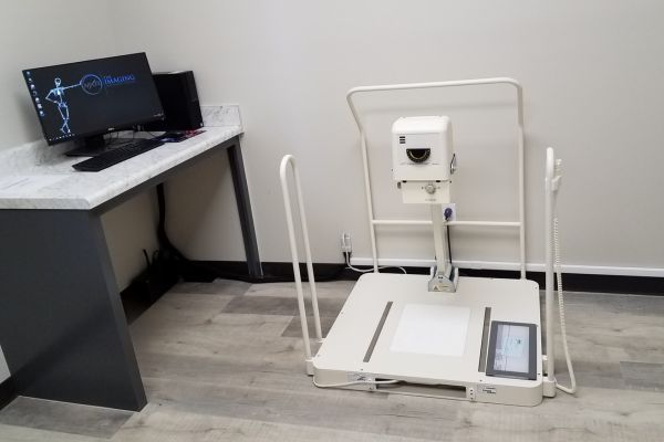 Weight-bearing podiatry X-ray system for foot and ankle imaging in a medical clinic.