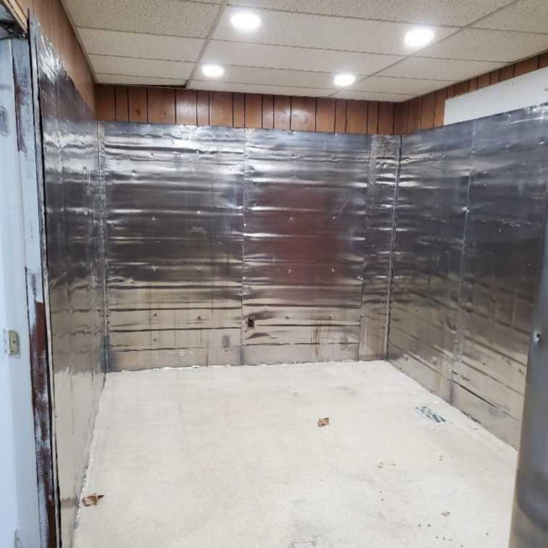 Radiation shielding for X-ray room construction using lead sheets for medical safety compliance.